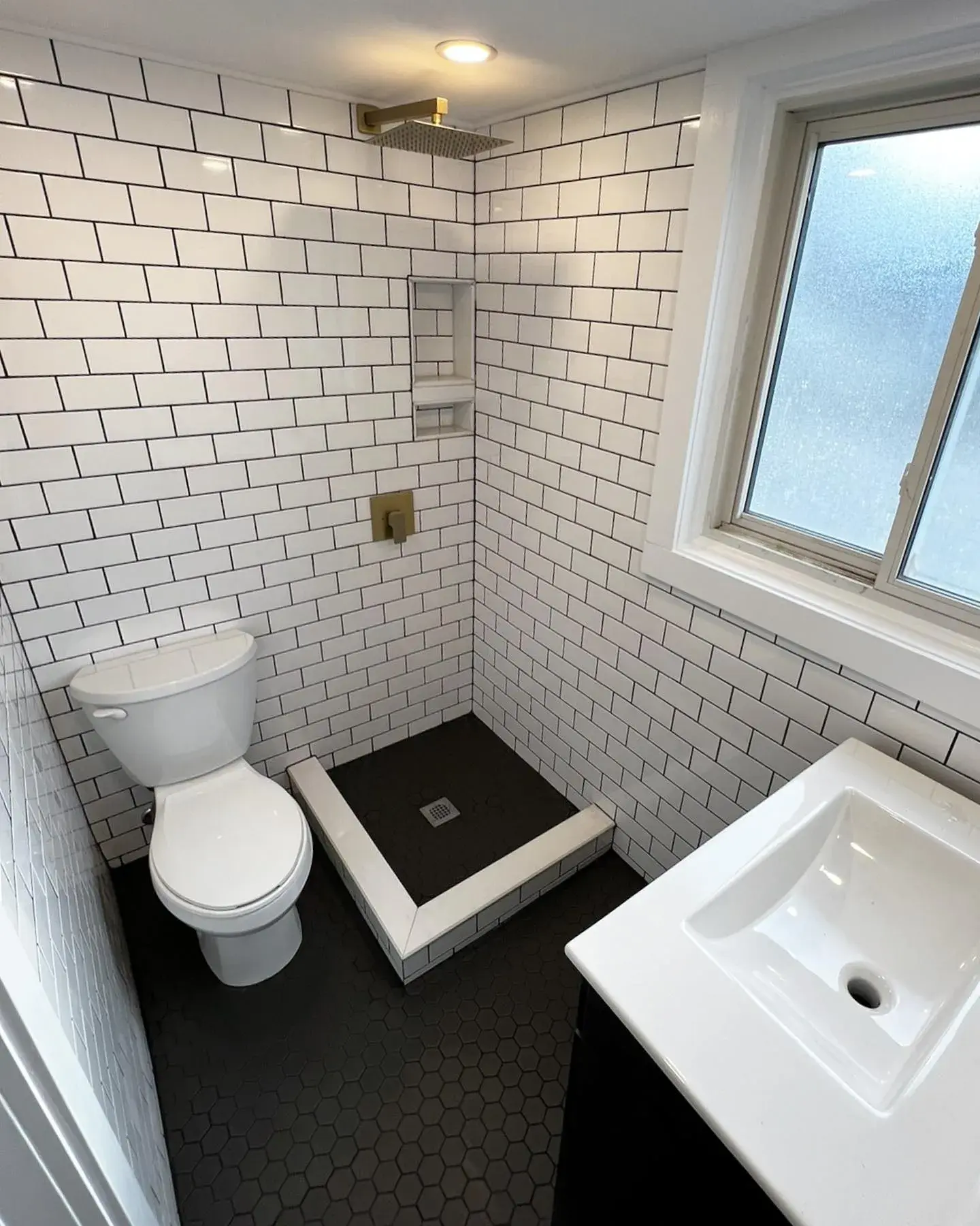 Compact white subway tile bathroom with shower and vanity